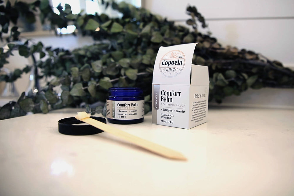 Copoeia Topical Soothing Salve Comfort Balm in a bathroom setting
